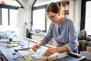 Glass artist craftswoman working in her studio