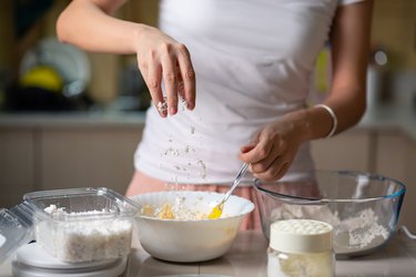 Woman adding grated ingredients