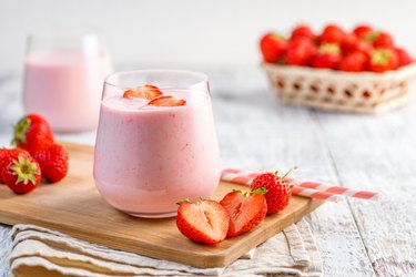Glass with strawberry smoothie or milkshake.