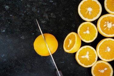 Knife cutting oranges