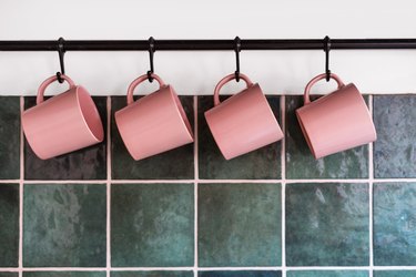 Metal hanging rack with mugs in kitchen