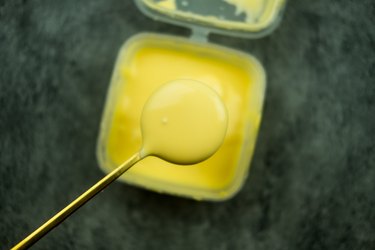 Spoon with delicious melted cheese
