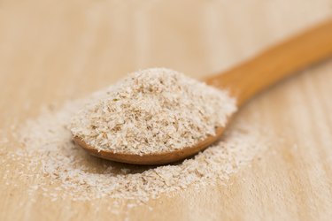 Wooden spoon heaped with psyllium seeds