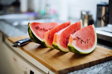 Watermelon sliced on a kitchen counter