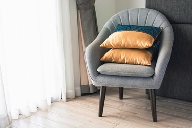 Soft armchair with pillows in the hotel room. The concept of old age and tranquility.