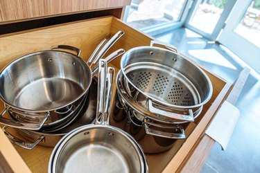Stainless Steel Pots and Pans in a Wooden Drawer
