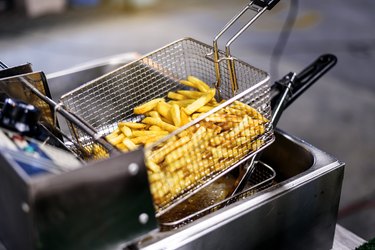 French fries Potatoes in a deep fryer basket