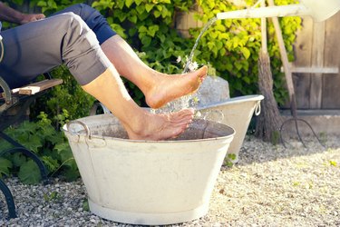 Man taking footbath in a garden