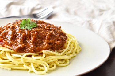 Spaghetti Bolognese on a white plate.