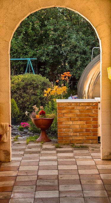 An arch separating a patio into different areas.