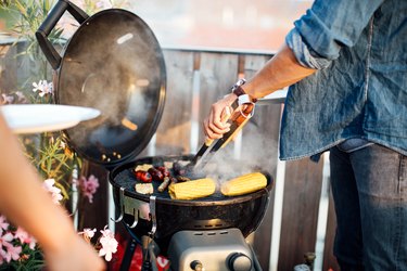 Man cooking sausages on barbecue grill