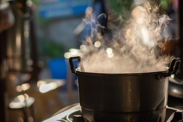 Metal pot boiling on stove