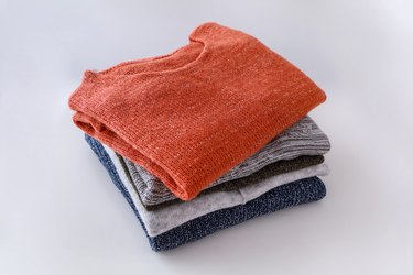 High Angle View Of Sweaters Against White Background