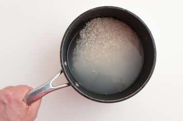 Basmati rice and water in cooking pan