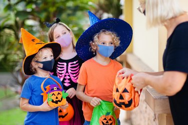 Kids trick or treat. Halloween in face mask.