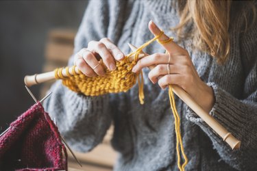 Close up on woman's hands knitting