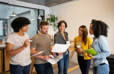 Group of creative business people sharing ideas in a meeting at the office