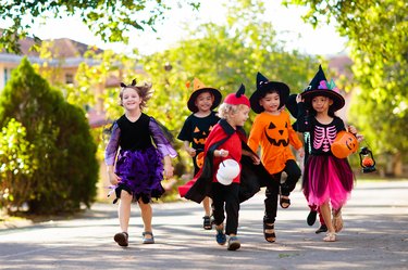 Kids trick or treat. Halloween fun for children.