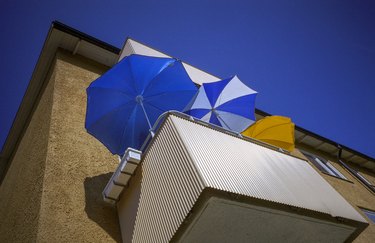 Three Umbrellas On Apartment Balcony