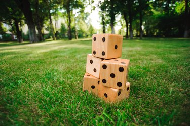 Big dice on green grass