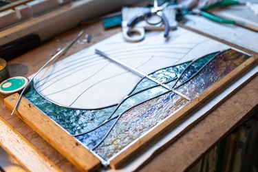 A woman who makes stained glass at home.