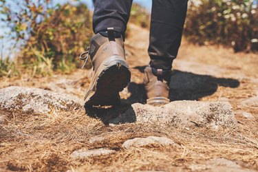 Low Section Of Woman Walking On Cliff