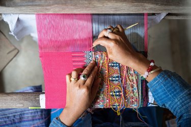 Cropped Image Of Hands Weaving On Hand Loom
