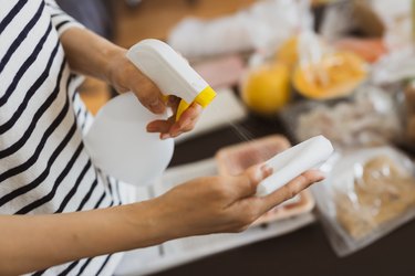 Woman disinfecting food delivered to her home