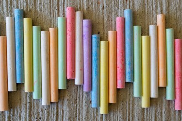 multi-colored crayons for children's creativity on a stone surface