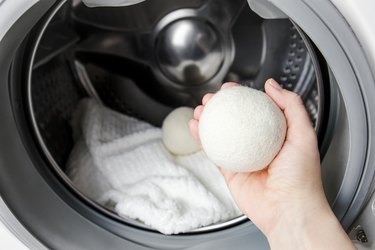 Woman using wool dryer balls