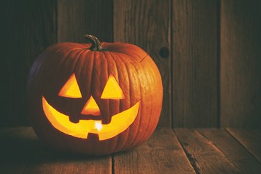 Halloween Jack O' lantern on rustic wooden background