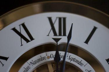 Vintage grandfather clock at 12 o'clock roman numerals