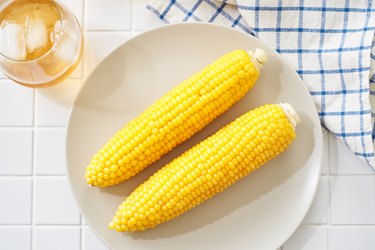 Simple steamed corn on the cob served on a plate