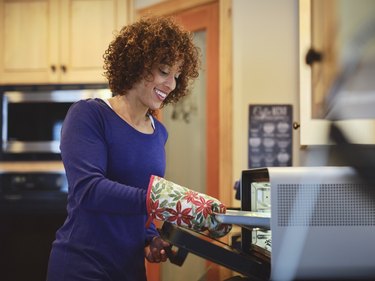 Woman Using an Oven in a Kitchen