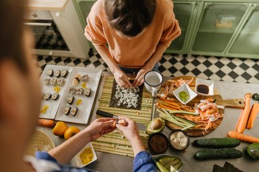 Friends making homemade sushi