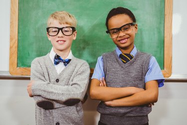 Smart students standing in front of a blackboard