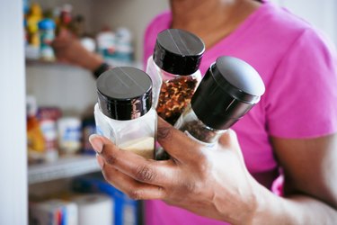 Woman Grabs Spices From Pantry