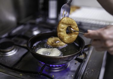 Baking donuts in a pan filled with hot oil