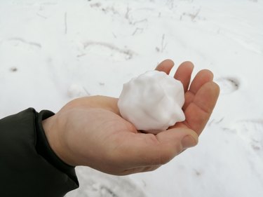 A snowball in a man's hand