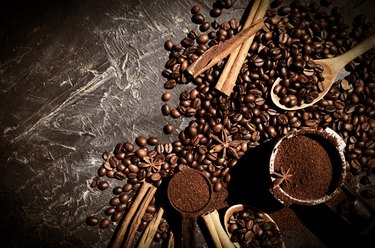 Coffee beans, cinnamon on a dark background