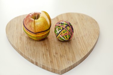 Cut apple and ball of rubber bands