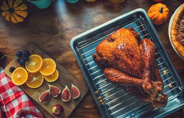 Preparing stuffed turkey with side dishes for the holidays