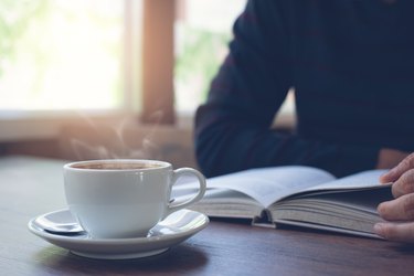 Man reading book with coffee