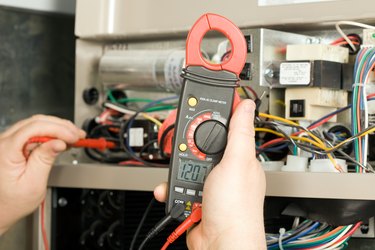 Repairman Checks Voltage on Geothermal HVAC System
