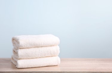 Stack of folded towels on wood surface