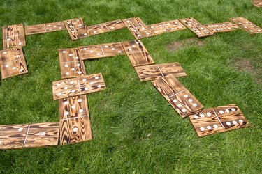 Large wooden dominoes laid out on the lawn