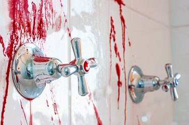 Simulated bathroom murder scene with blood splattering