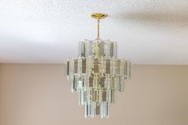 An old-fashioned retro hanging glass chandelier in a dining room