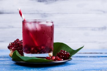 Pomegranate drink with striped straw