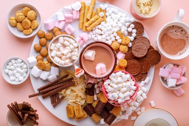 Hot chocolate, marshmallows, chocolates and cookies on board